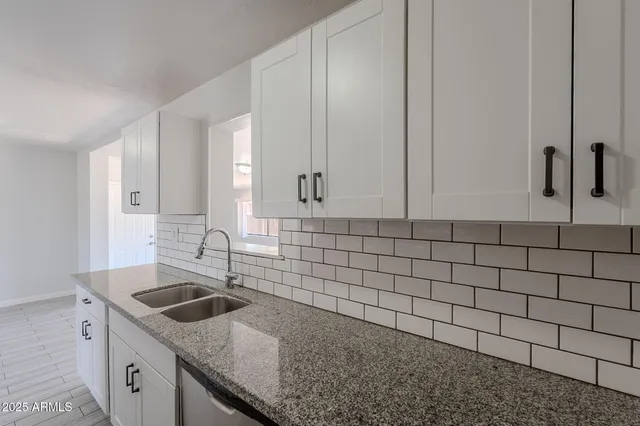 a kitchen with a sink and cabinets