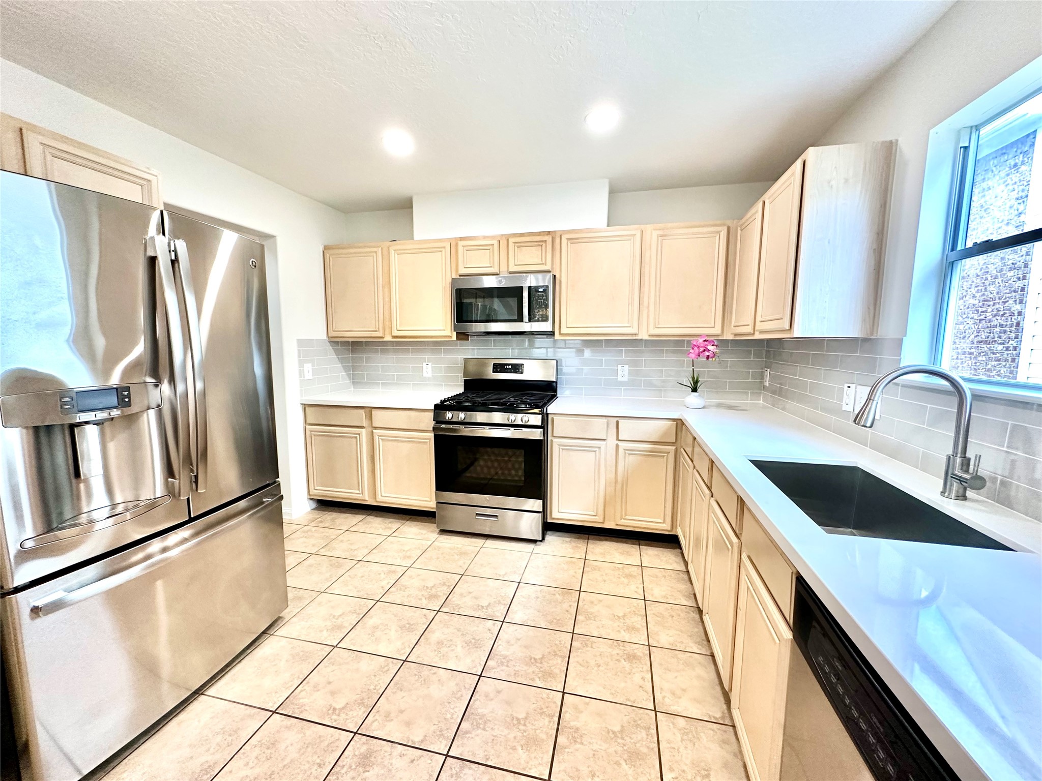 25311 Clover Ranch Drive Katy, TX 77494 - Photo 8 of 27 Kitchen with plenty of natural light. Stainless Steel fridge included