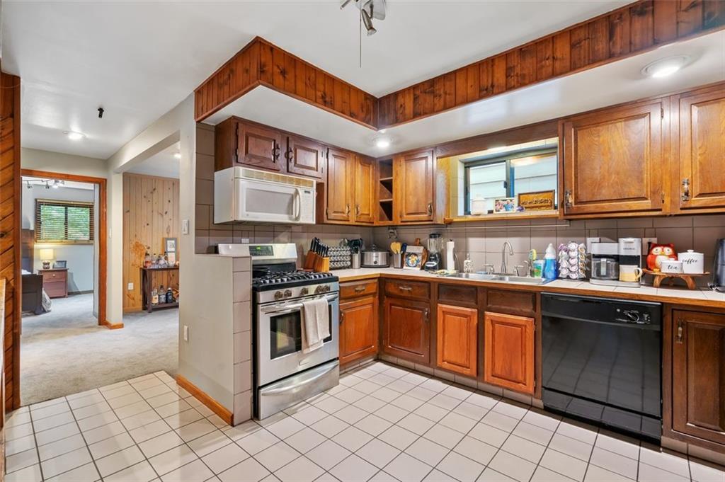 121 Frazier Avenue McKees Rocks, PA 15136 - Photo 8 of 29 a kitchen with stainless steel appliances granite countertop a stove sink and cabinets