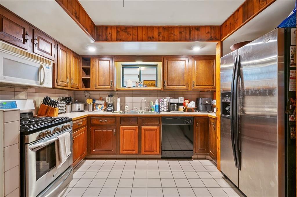 121 Frazier Avenue McKees Rocks, PA 15136 - Photo 9 of 29 a kitchen with stainless steel appliances granite countertop a refrigerator and a sink