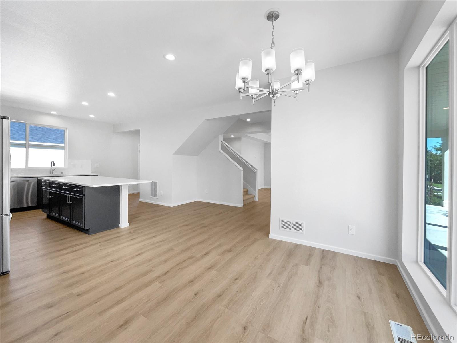 12825 Eagle River Road Firestone, CO 80504 - Photo 11 of 32 a view of a kitchen with granite countertop a stove top oven a sink and a wooden floor