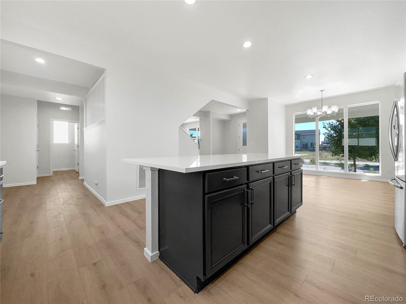 12825 Eagle River Road Firestone, CO 80504 - Photo 15 of 32 a kitchen with stainless steel appliances granite countertop a stove and a wooden floors