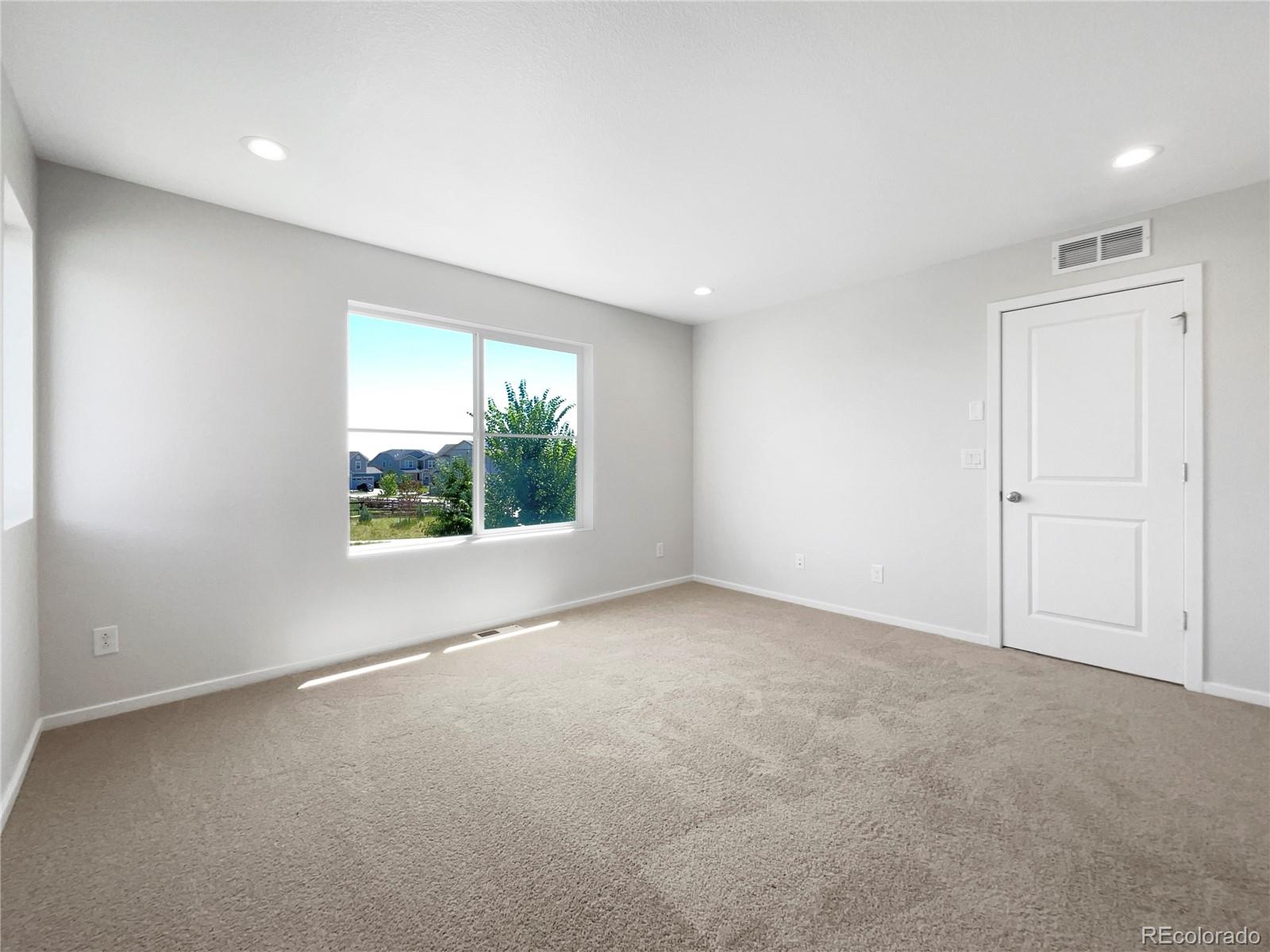 12825 Eagle River Road Firestone, CO 80504 - Photo 20 of 32 an empty room with windows and closet