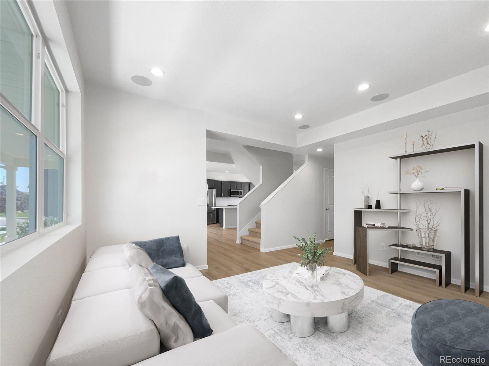 12825 Eagle River Road Firestone, CO 80504 - Photo 2 of 32 a living room with furniture and a dining table with kitchen view