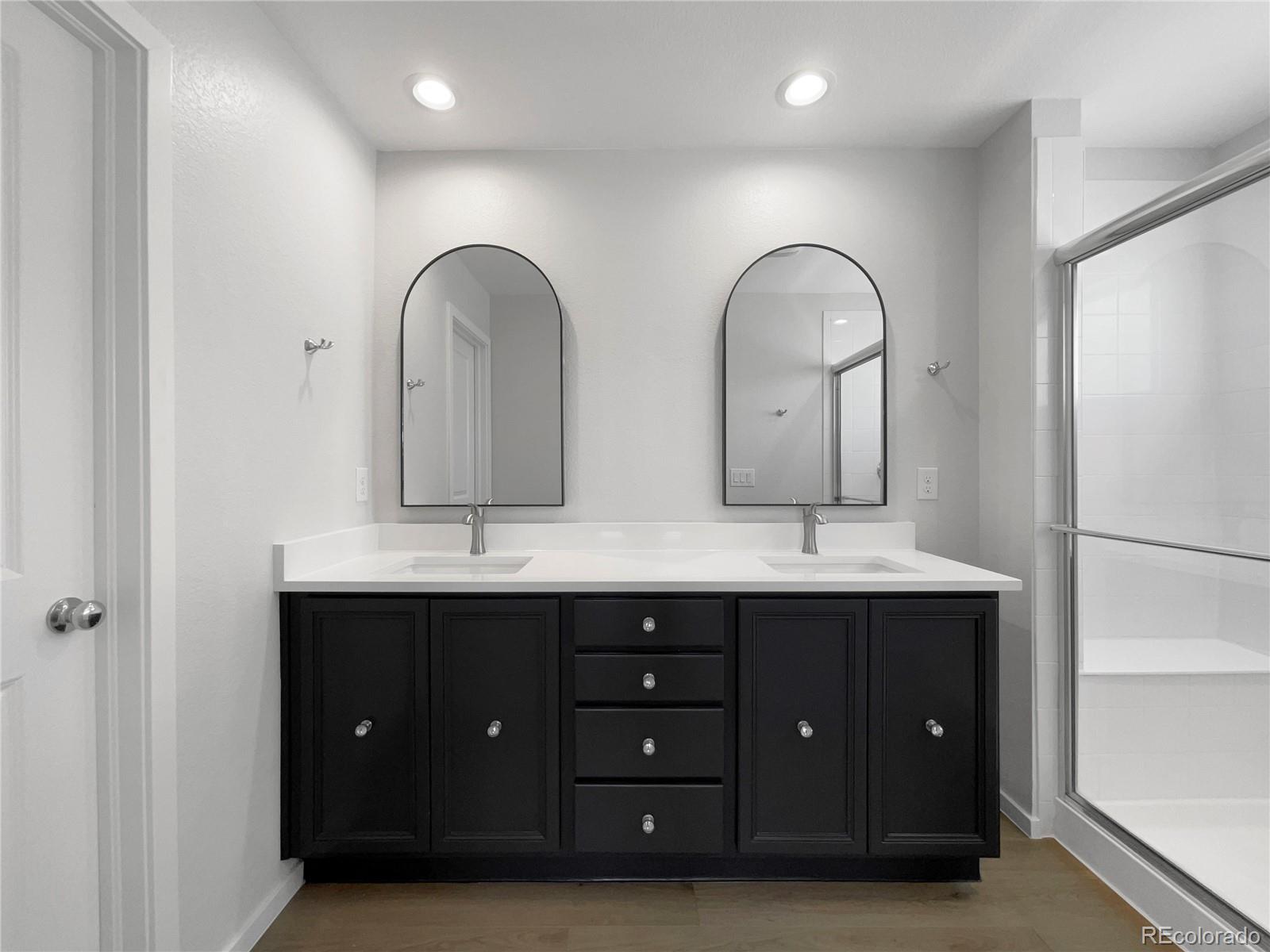 12825 Eagle River Road Firestone, CO 80504 - Photo 22 of 32 a bathroom with a double vanity sink and a