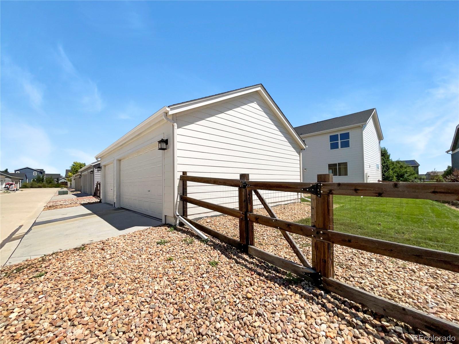 12825 Eagle River Road Firestone, CO 80504 - Photo 31 of 32 a view of a house with backyard and a garden