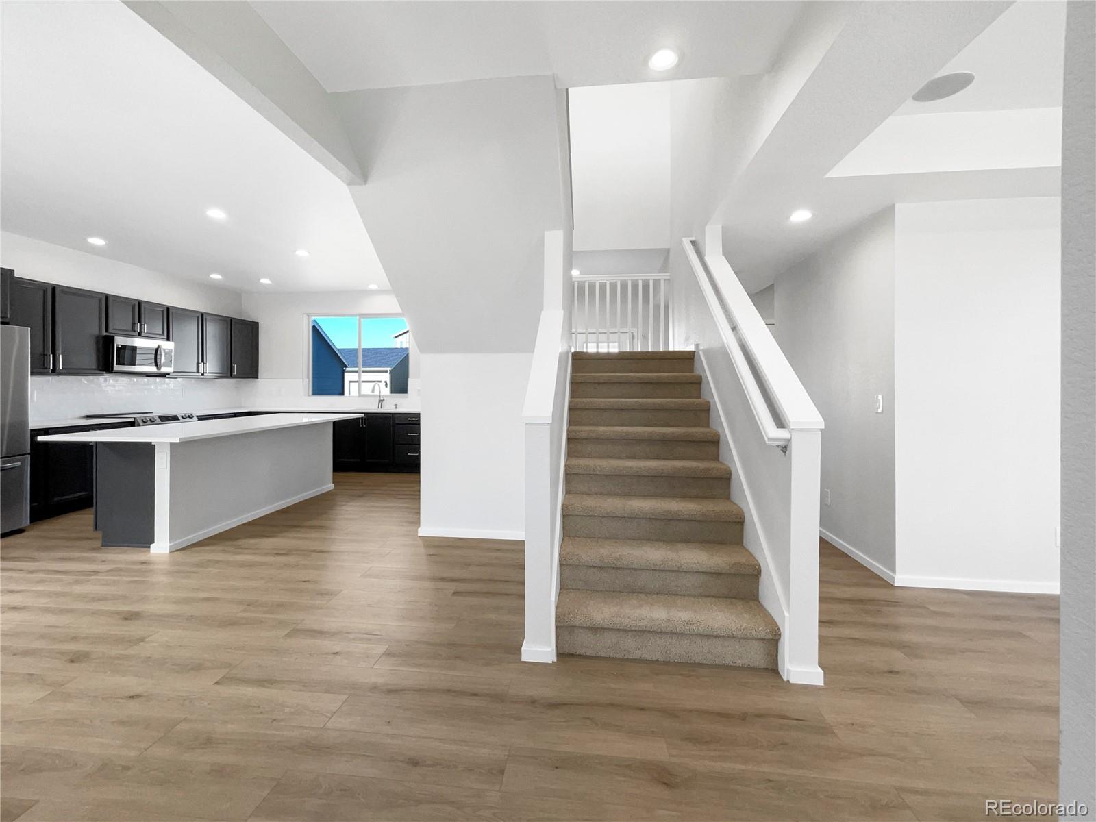 12825 Eagle River Road Firestone, CO 80504 - Photo 9 of 32 a view of kitchen with cabinets and wooden floor