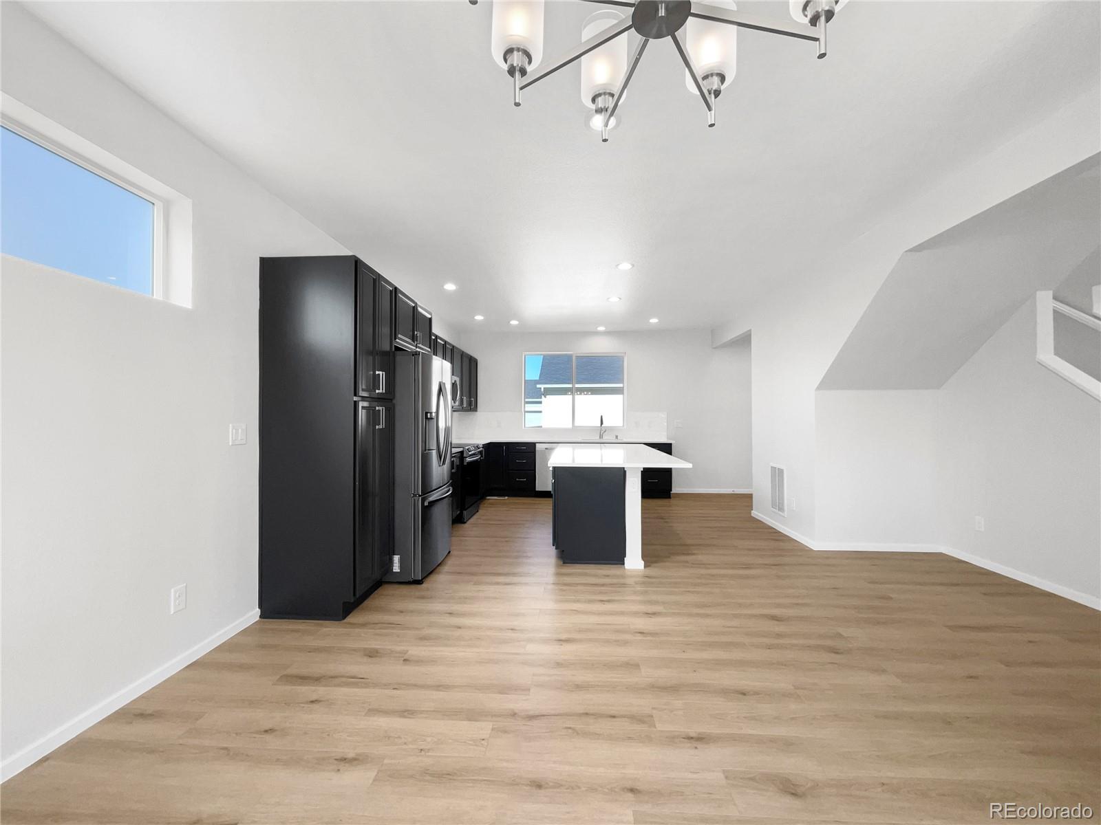 12825 Eagle River Road Firestone, CO 80504 - Photo 10 of 32 a view of a kitchen with a refrigerator and a window