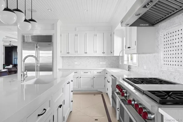 a kitchen with a stove a sink and a refrigerator