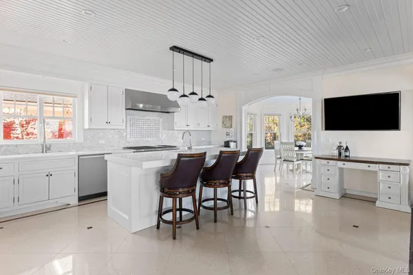 a dining room with furniture a chandelier and wooden floor