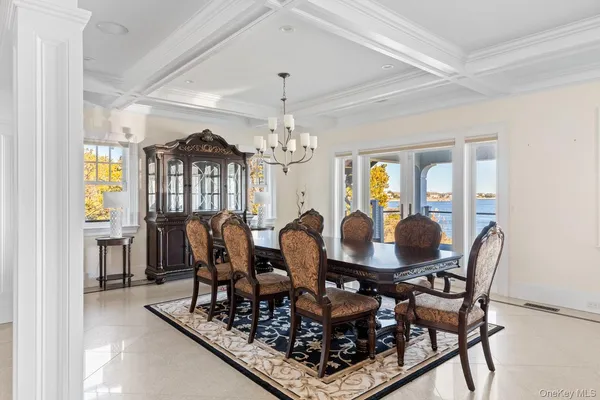 a view of a dining room with furniture large windows and wooden floor