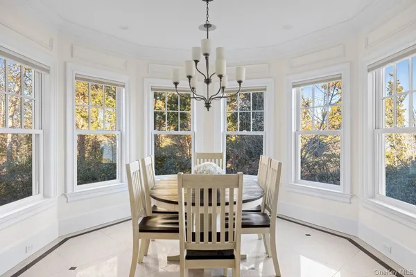 a living room with furniture and large windows
