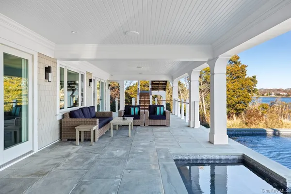 a dining room with furniture and a floor to ceiling window