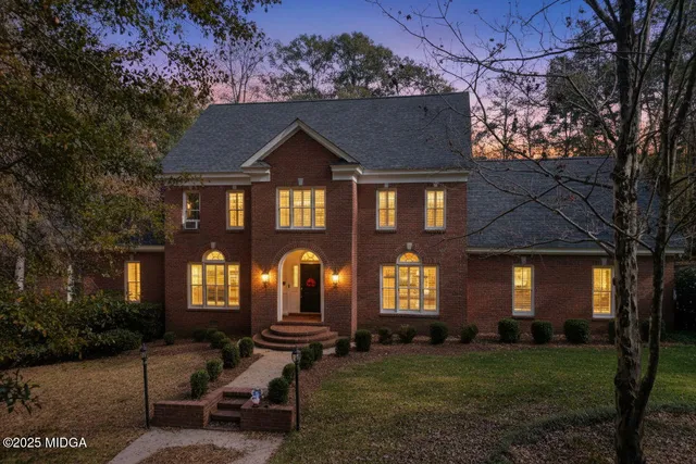 a front view of a house with a garden