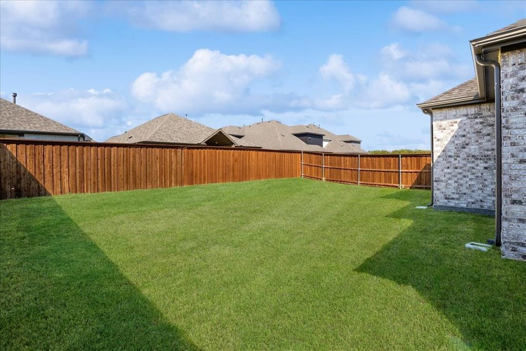 1710 Highwood Road Forney, TX 75126 - Photo 19 of 25 Expansive green lawn surrounded by a privacy fence