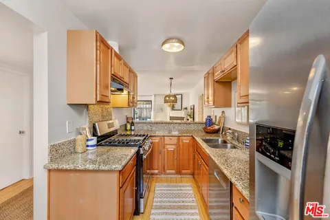 a kitchen with stainless steel appliances granite countertop a stove and a sink