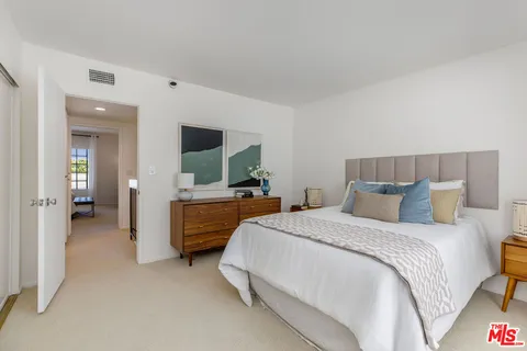a bedroom with a bed and walk in closet