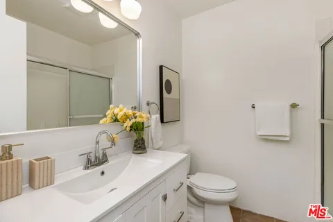 a bathroom with a sink toilet and mirror