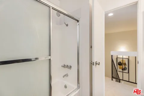 a bathroom with a shower and a bath tub
