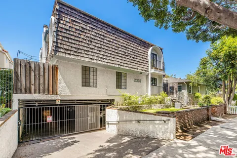 a front view of a house with a wooden fence