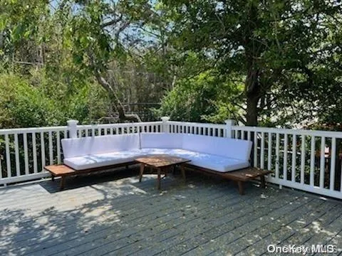 a outdoor sitting area with wooden deck and yard