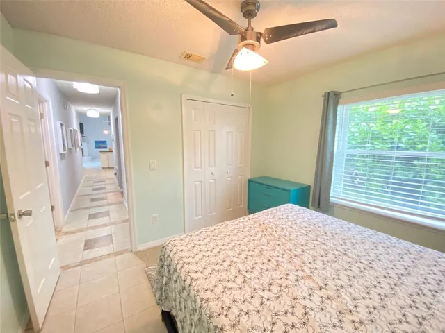 a view of a bedroom with wooden floor and windows