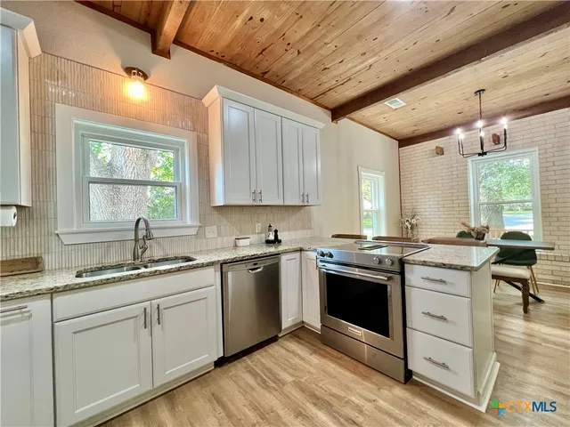 a kitchen with a sink stove and cabinets