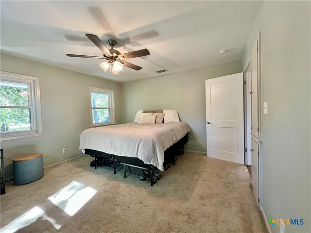 a bathroom with a granite countertop toilet sink and mirror