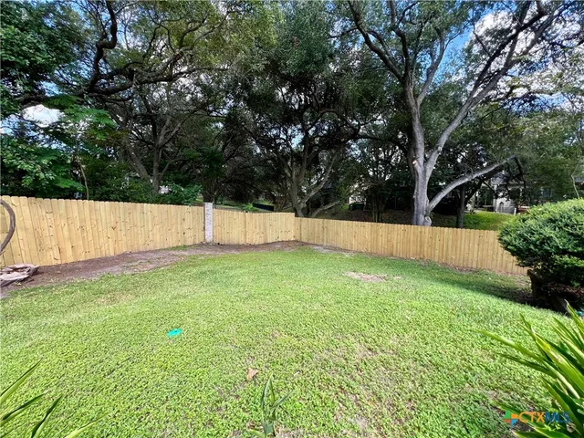 an aerial view of a house with a swimming pool and garden