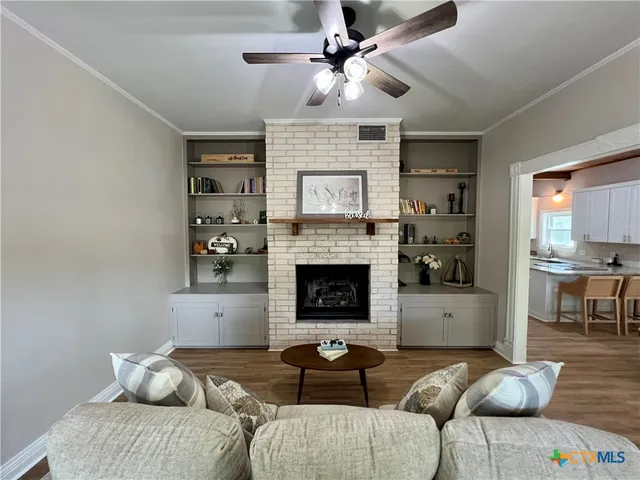 a living room with furniture and a fireplace