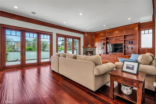 a living room with fireplace furniture and a large window