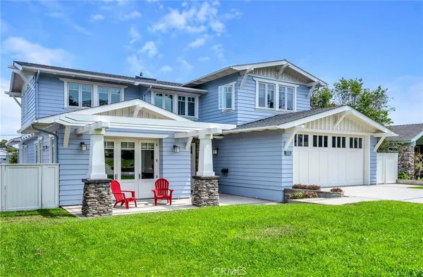 a front view of a house with a yard and porch