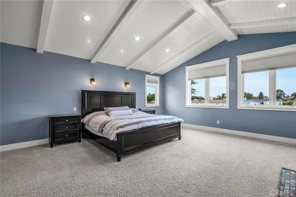 a spacious bedroom with a bed and window