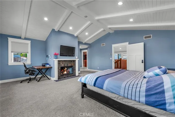 a bedroom with a bed and a fireplace