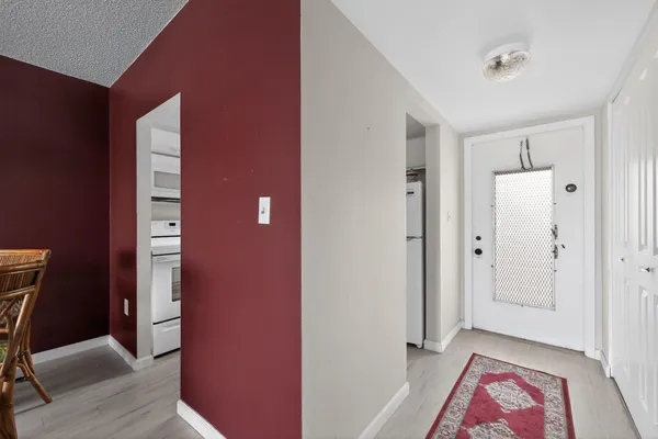 a view of room with walk in closet and wooden floor