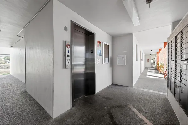 a view of a hallway with wooden shelves