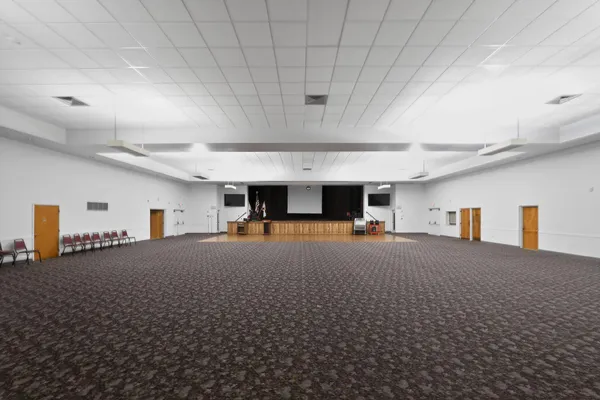 a living room with a table a table and chairs