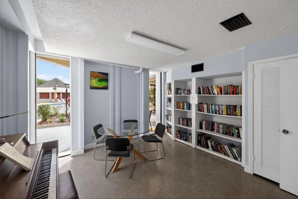a living room with furniture and a book shelf
