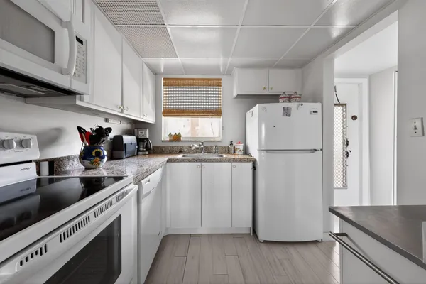 a kitchen with a refrigerator a sink and cabinets