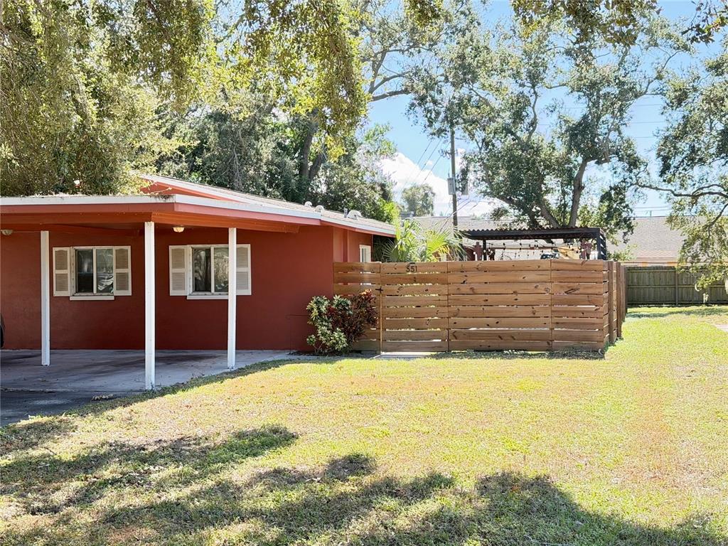 a view of a house with a yard covered with snow in the background