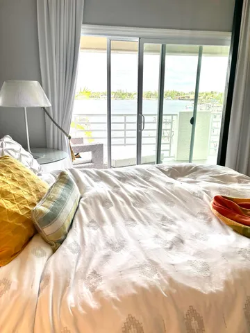 a bed sitting in a bedroom next to a window