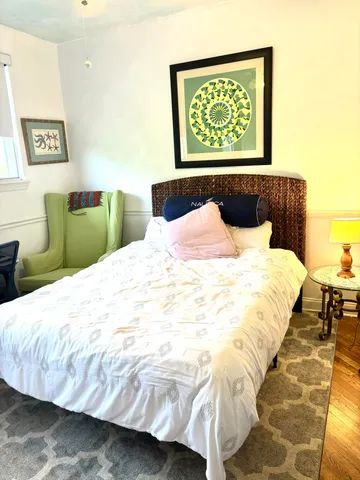 a bedroom with a bed and a night stand