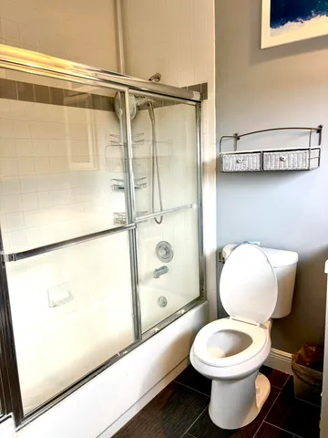 a bathroom with a toilet and a shower