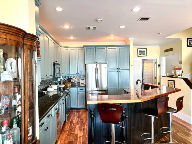 a kitchen with a sink refrigerator and cabinets