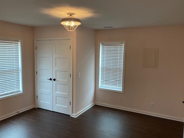 5919 River Road Flowery Branch, GA 30542 - Photo 10 of 18 a view of an empty room with a window and wooden floor