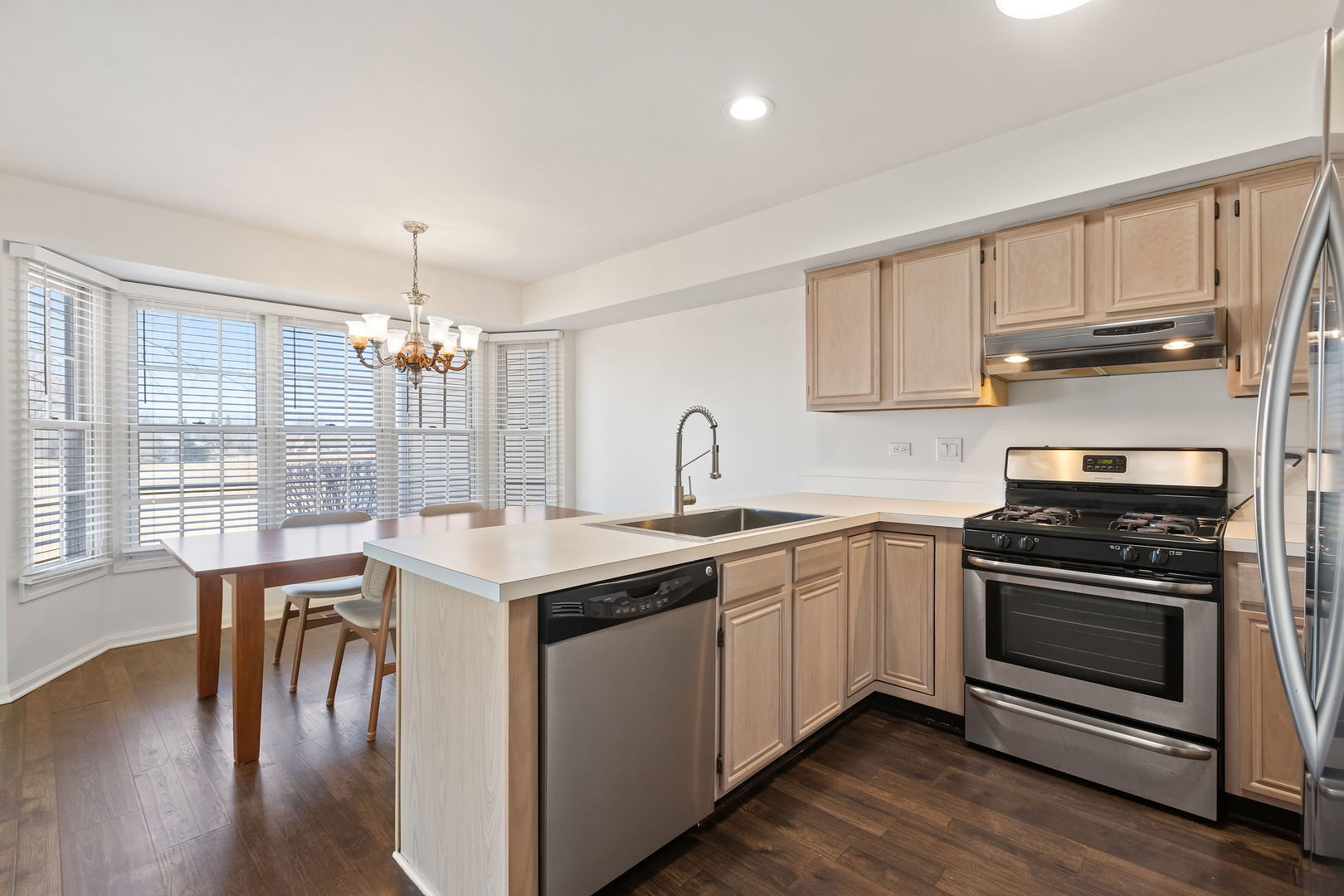 4875 Turnberry Drive Hoffman Estates, IL 60010 - Photo 9 of 22 a kitchen with stainless steel appliances granite countertop a stove and a sink