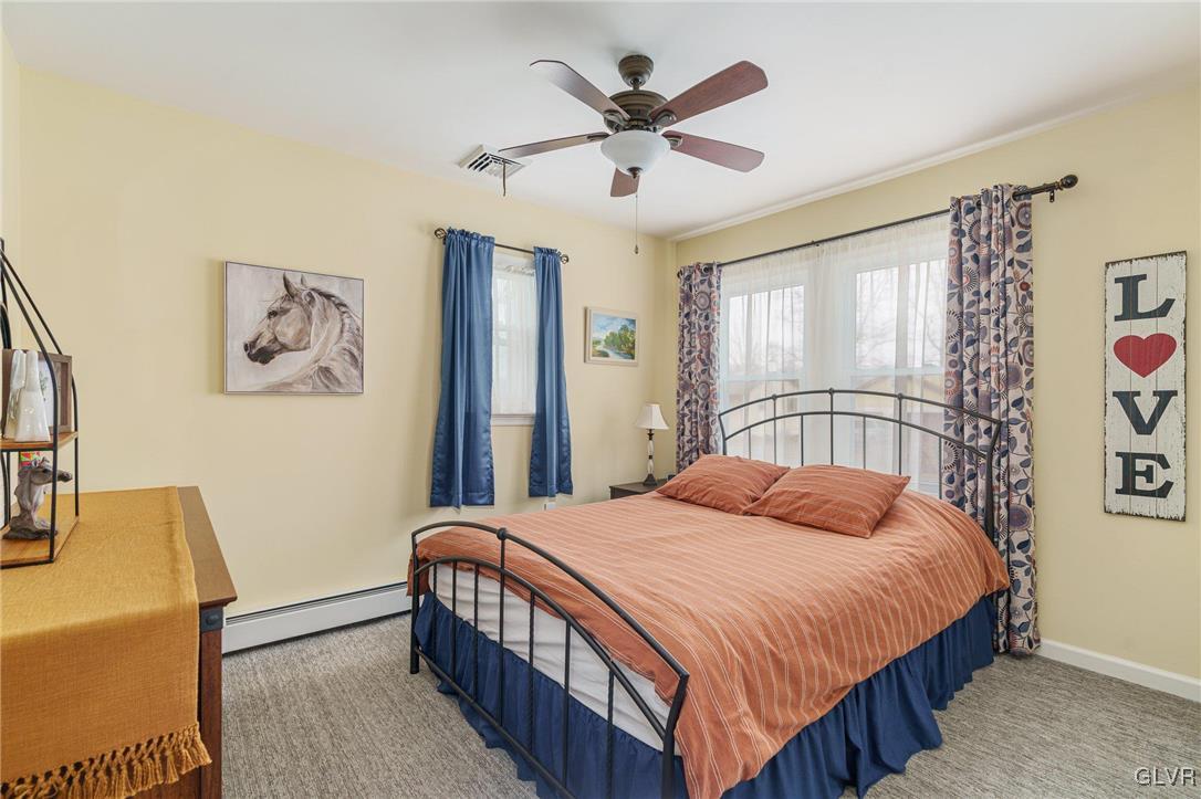 62 School Lane Reading, PA 19606 - Photo 28 of 33 a bedroom with a large bed and a chandelier