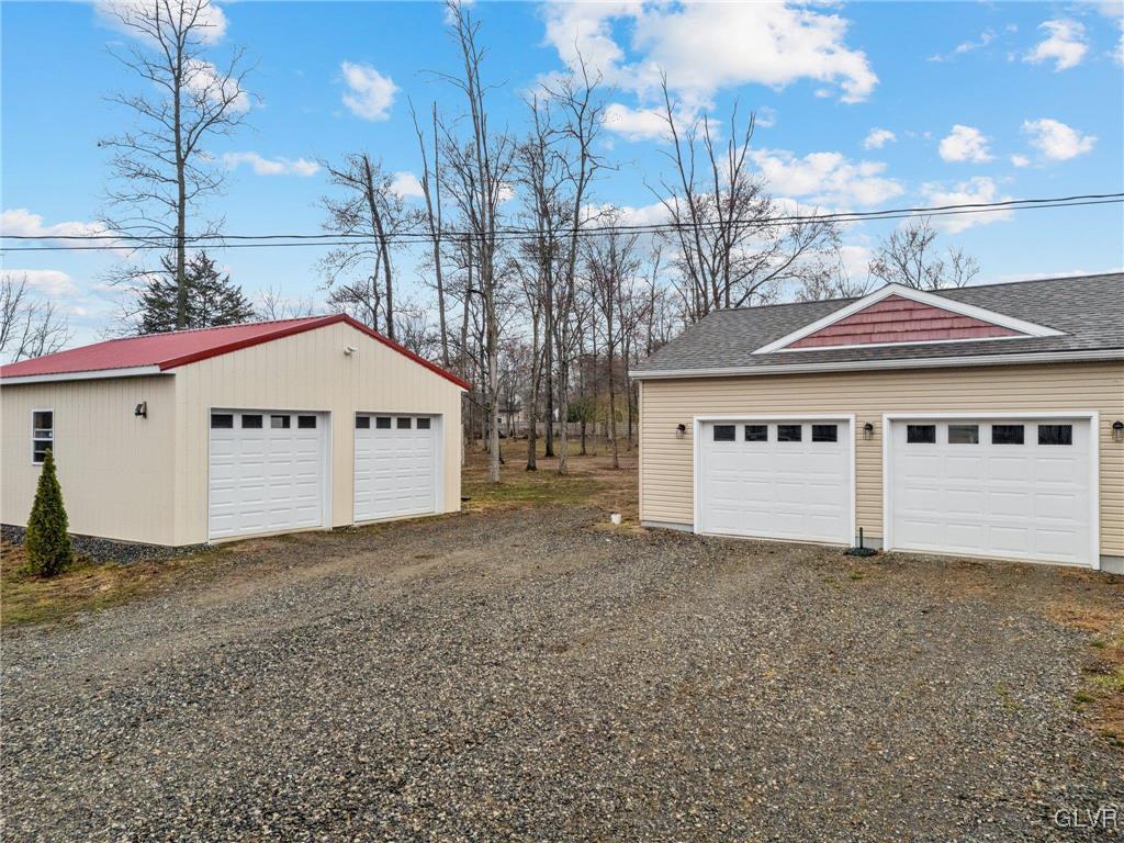 62 School Lane Reading, PA 19606 - Photo 7 of 33 a view of a house with a yard and garage