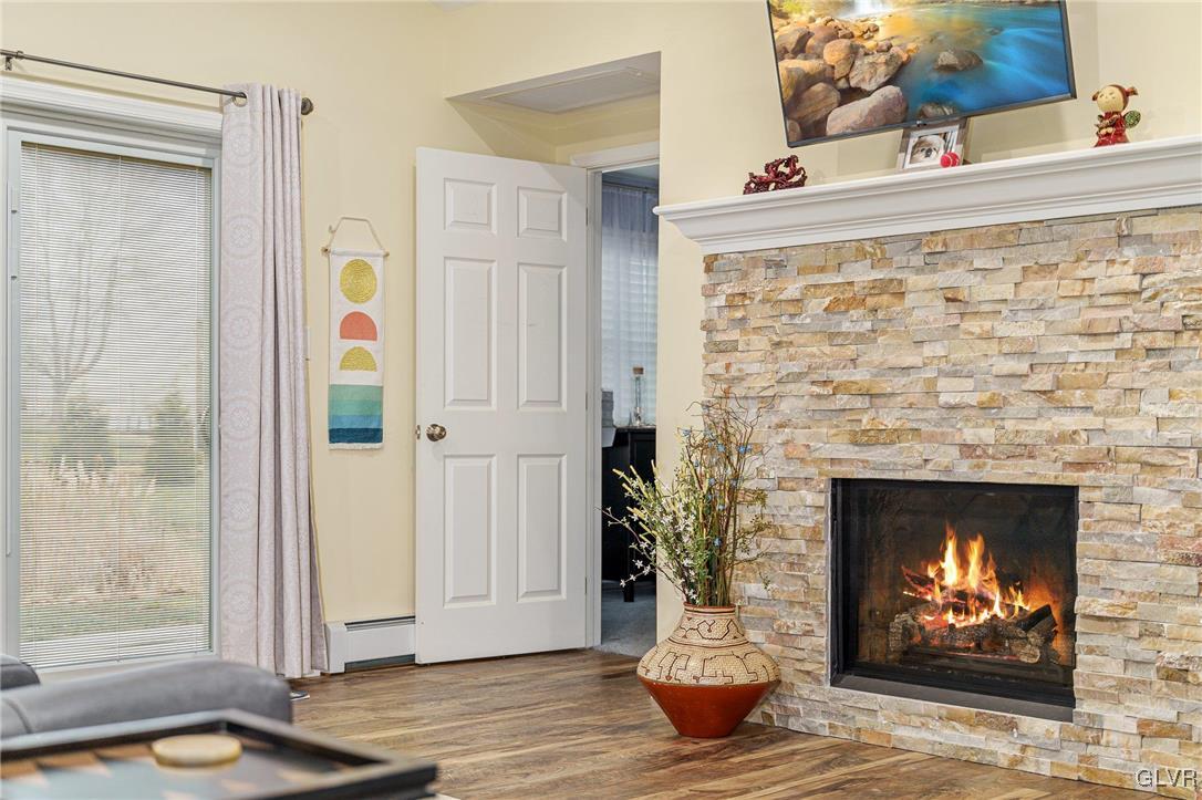 62 School Lane Reading, PA 19606 - Photo 10 of 33 a living room with a fireplace and a wooden floor