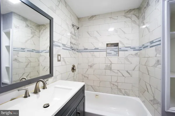 a bathroom with a sink shower and a bathtub